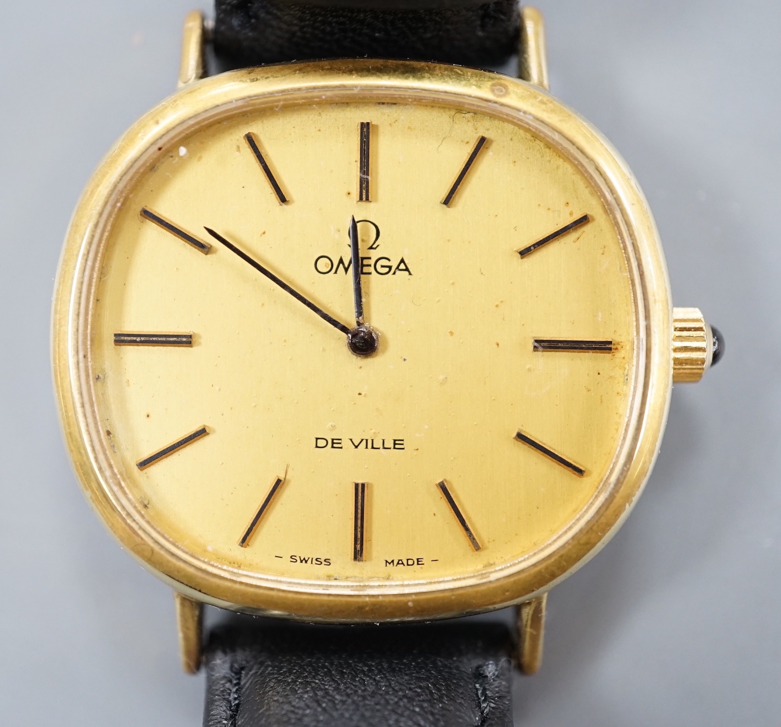 A gentleman's gold plated Omega de Ville manual wind wrist watch, on a black leather strap, with Omega buckle, case diameter 33mm, no box or papers.